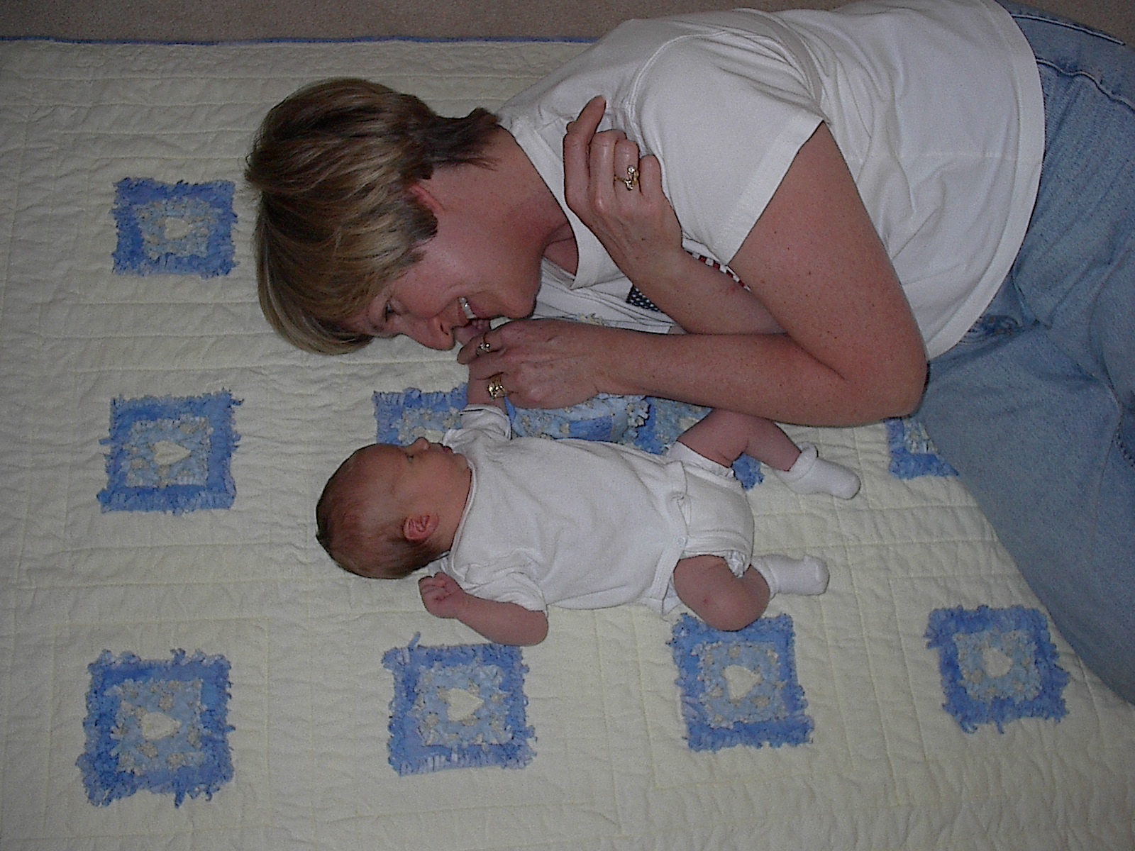 Grandma and Lexi on back of crib sized quilt